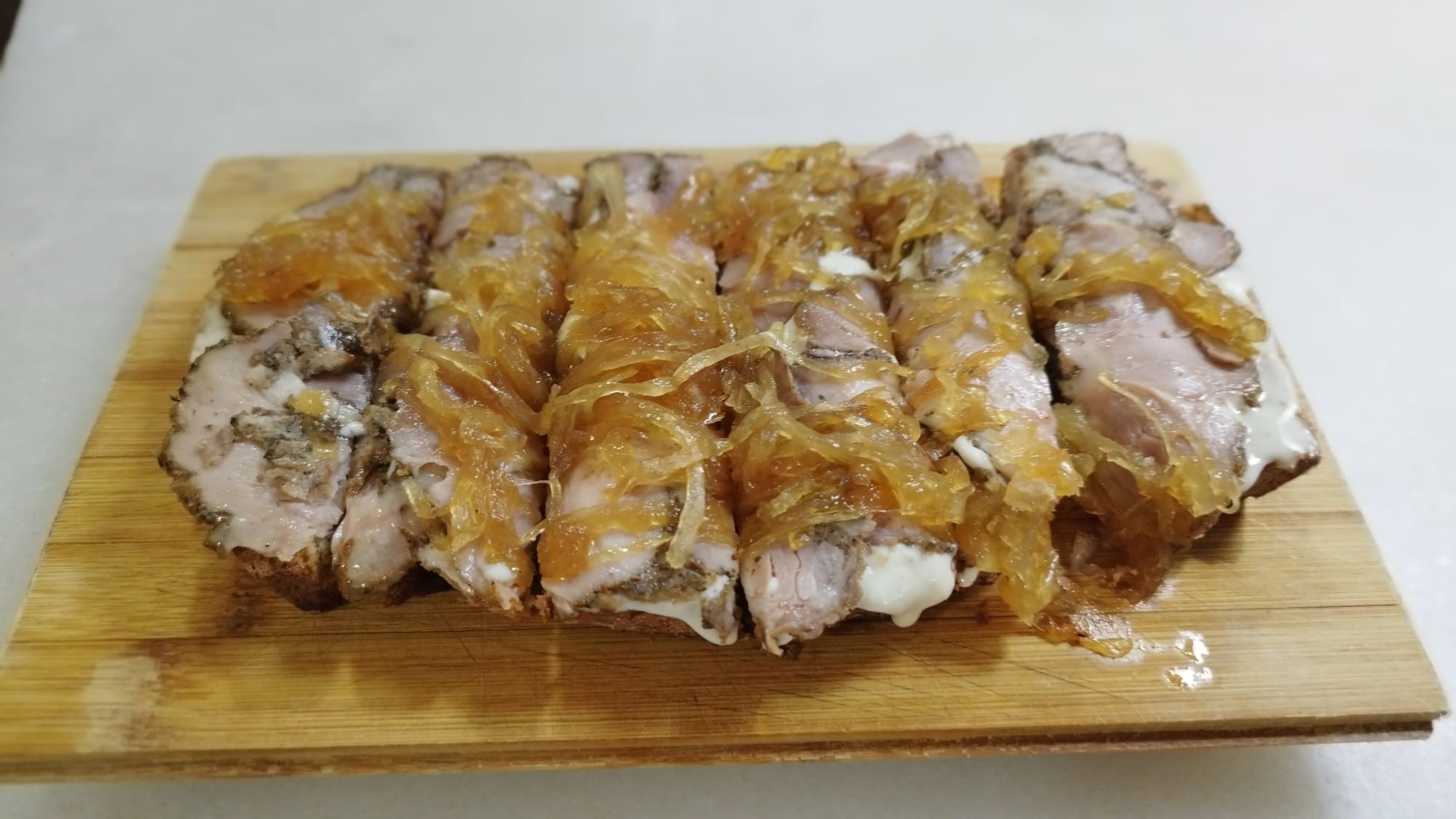 Carne mechada con salsa de queso viejo y cebolla caramelizada